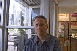 Tom at the Salad Creations restaurant after a long day, with the General Motors Building in the background